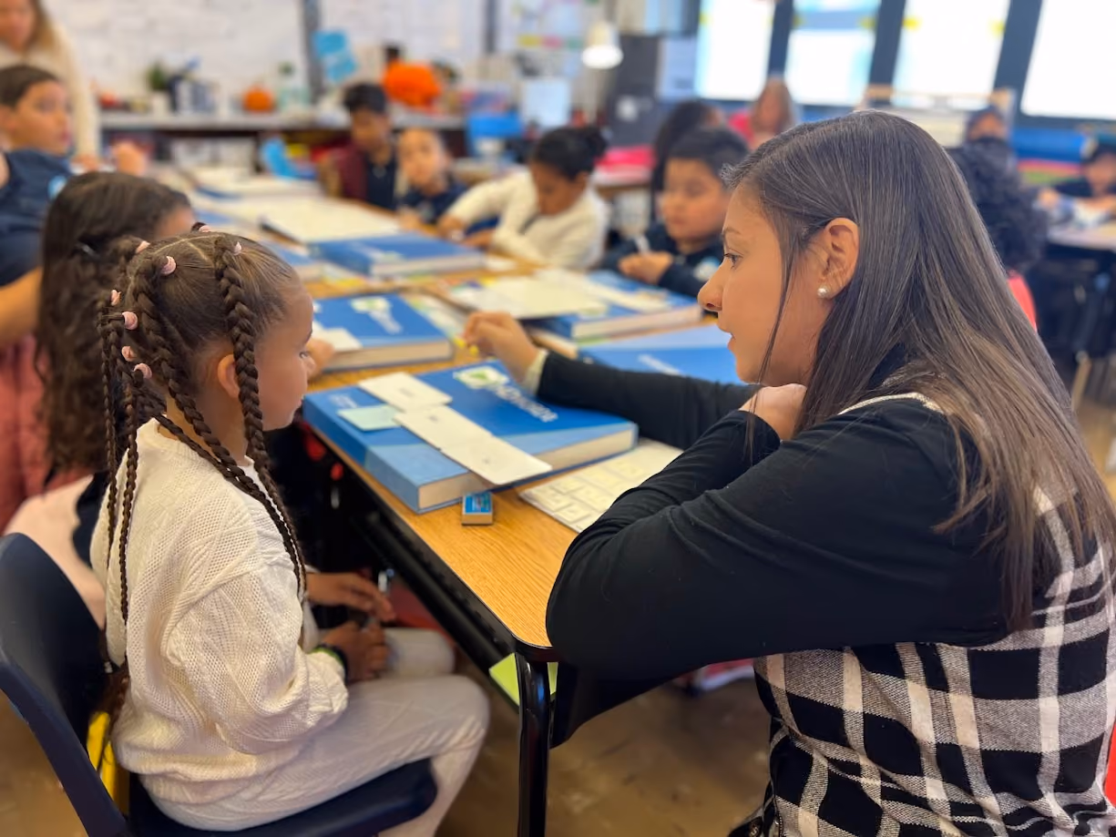 Teacher working one on one with a young elementary student