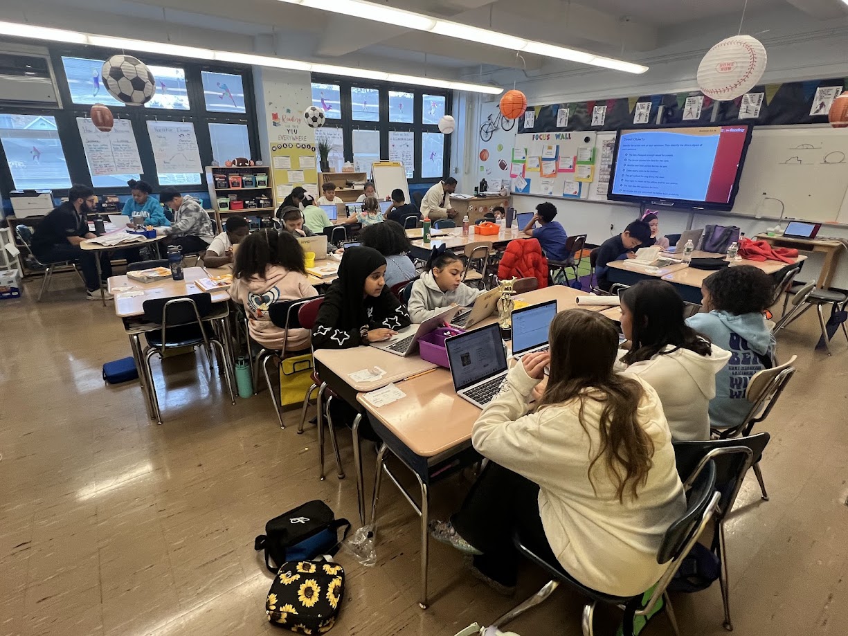 Middle school students working on laptops during a classroom lesson