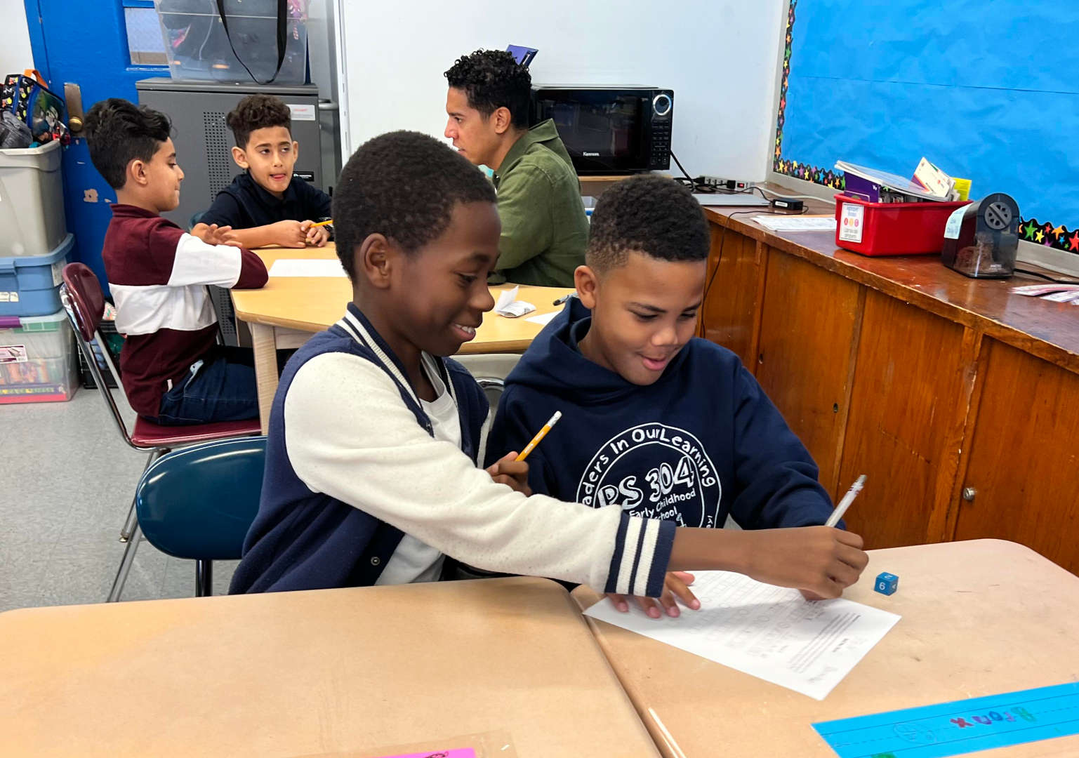Two students collaborating on a worksheet together in classroom