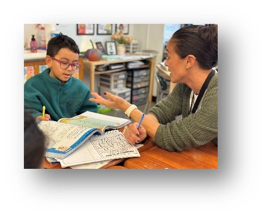 Teacher working one on one with a student over an open book
