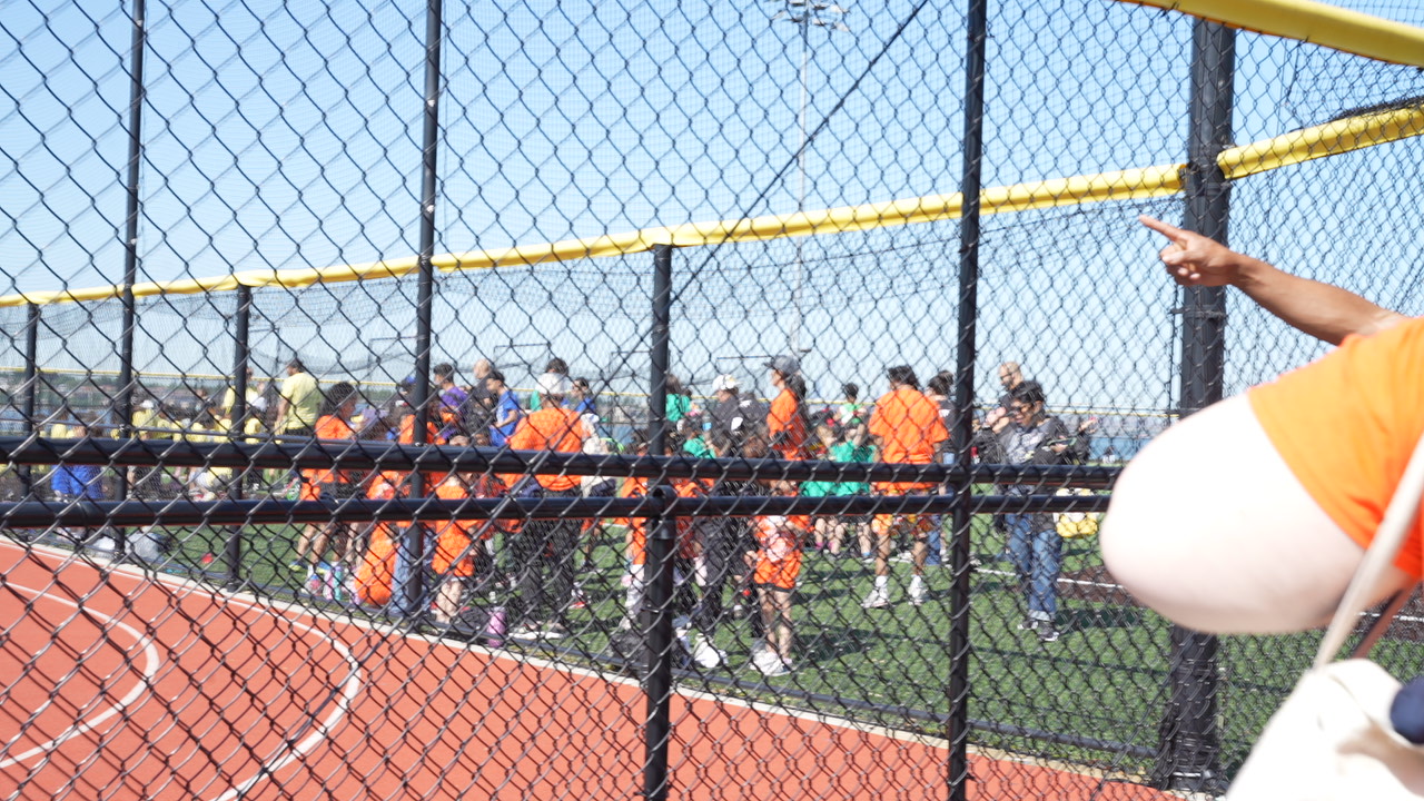 Students and staff gathered on athletic field during outdoor event