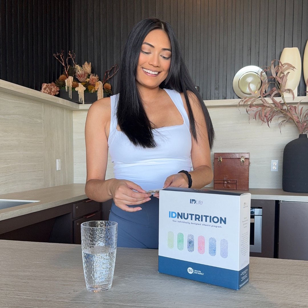Personalized IDNutrition morning and evening vitamin packs held in hand
