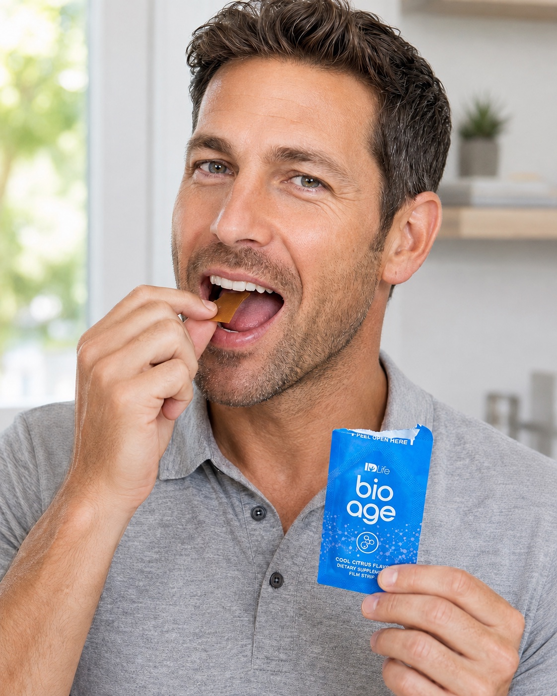 Man placing a BioAge dissolvable strip on his tongue while holding a BioAge sachet.