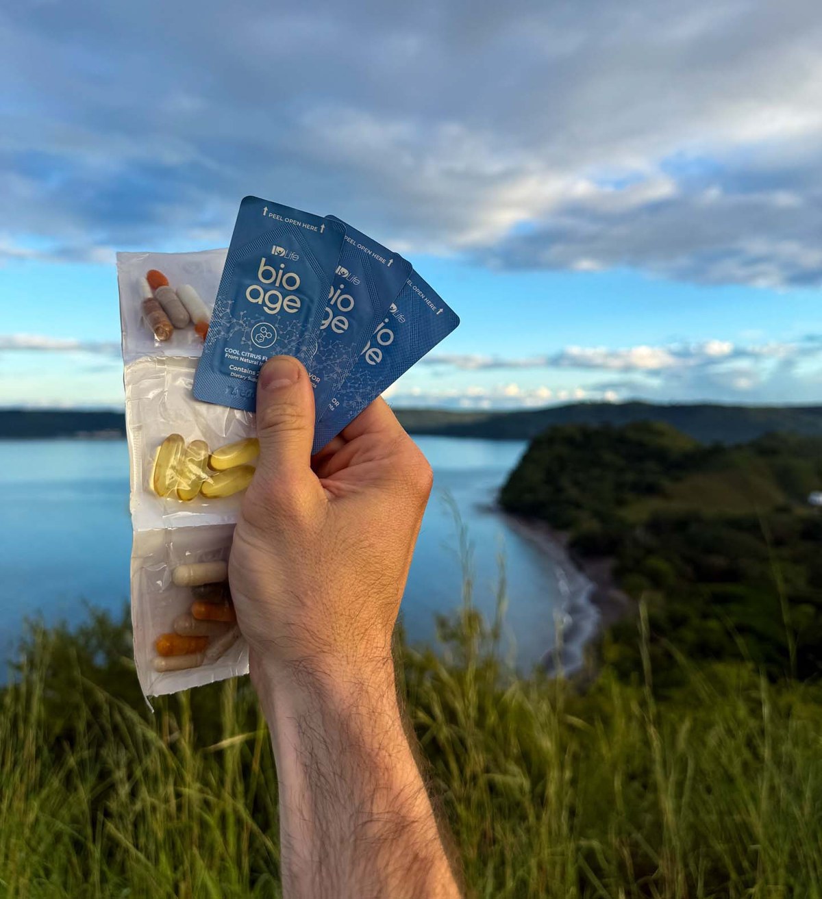 BioAge sachets and daily nutrition packets held beside the water.