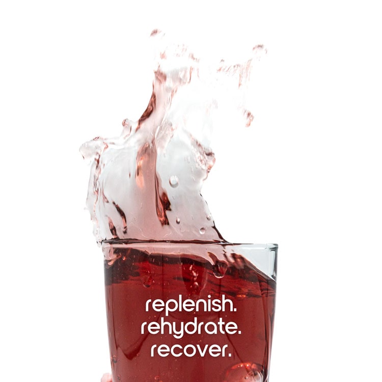 A glass of red Hydrate splashing, printed with replenish, rehydrate, recover