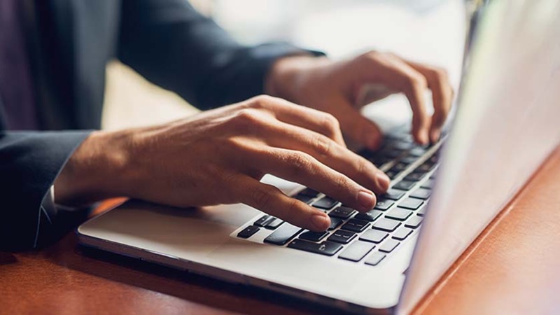 A person typing on a laptop.