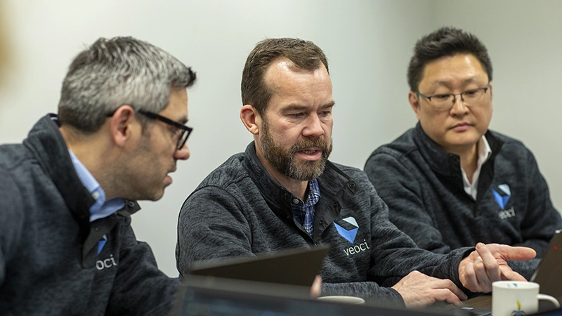 Veoci leaders review data and discuss operations.