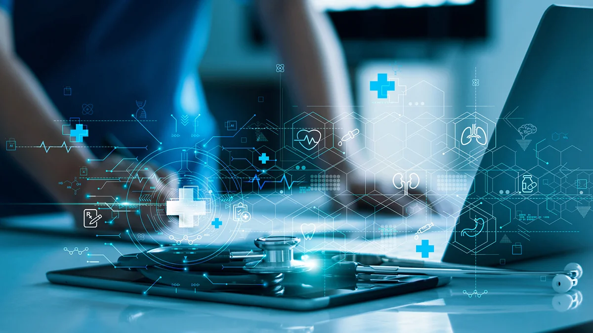 Hospital employee using AI on a tablet and laptop.