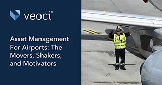 An airport employee directing aircraft on an airfield.