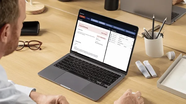 Higher education employee using Veoci on a laptop.
