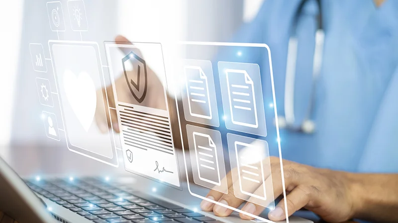 Medical professional using a laptop and AI to assist in their job.