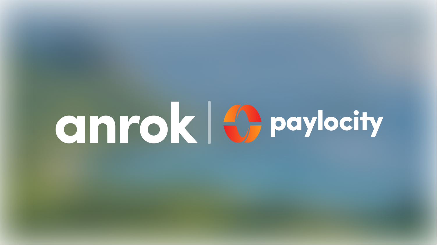 Anrok and Paylocity logos separated by vertical line on blurred background.