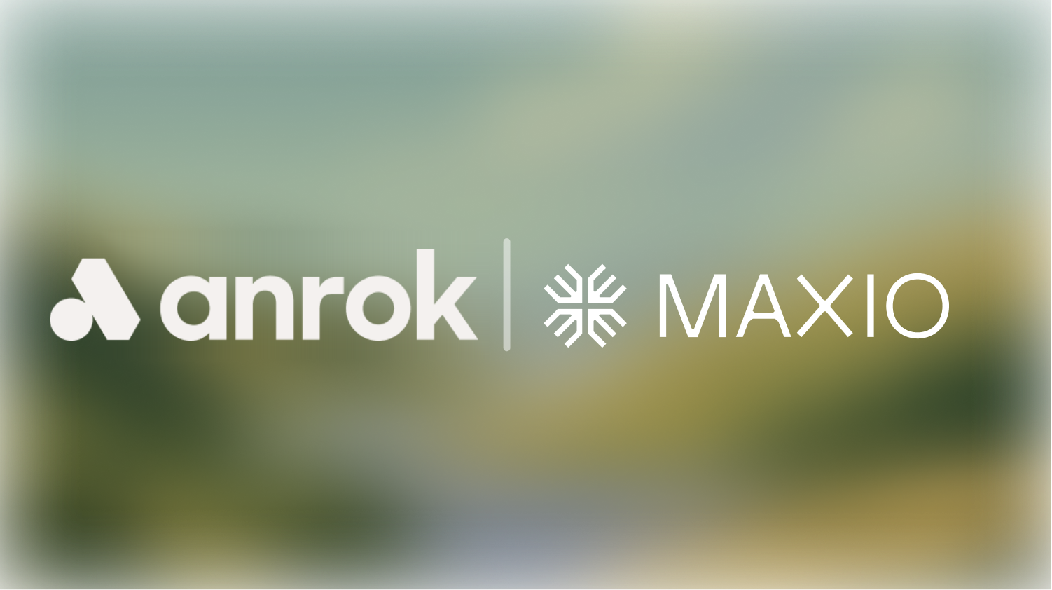 White Anrok and Maxio logos side by side on a blurred outdoor background.