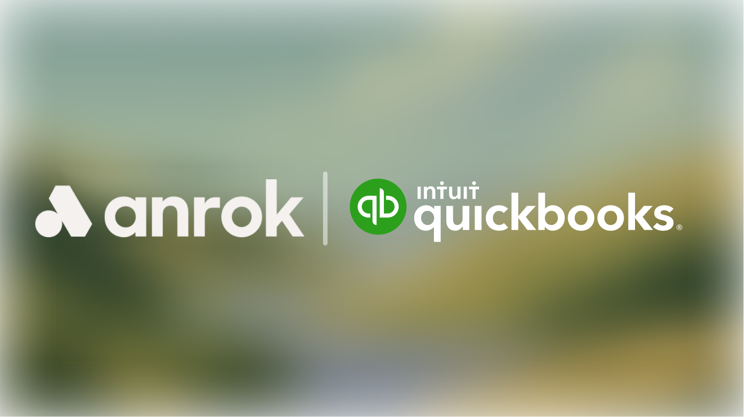 Anrok and Intuit QuickBooks logos side by side on a blurred background.