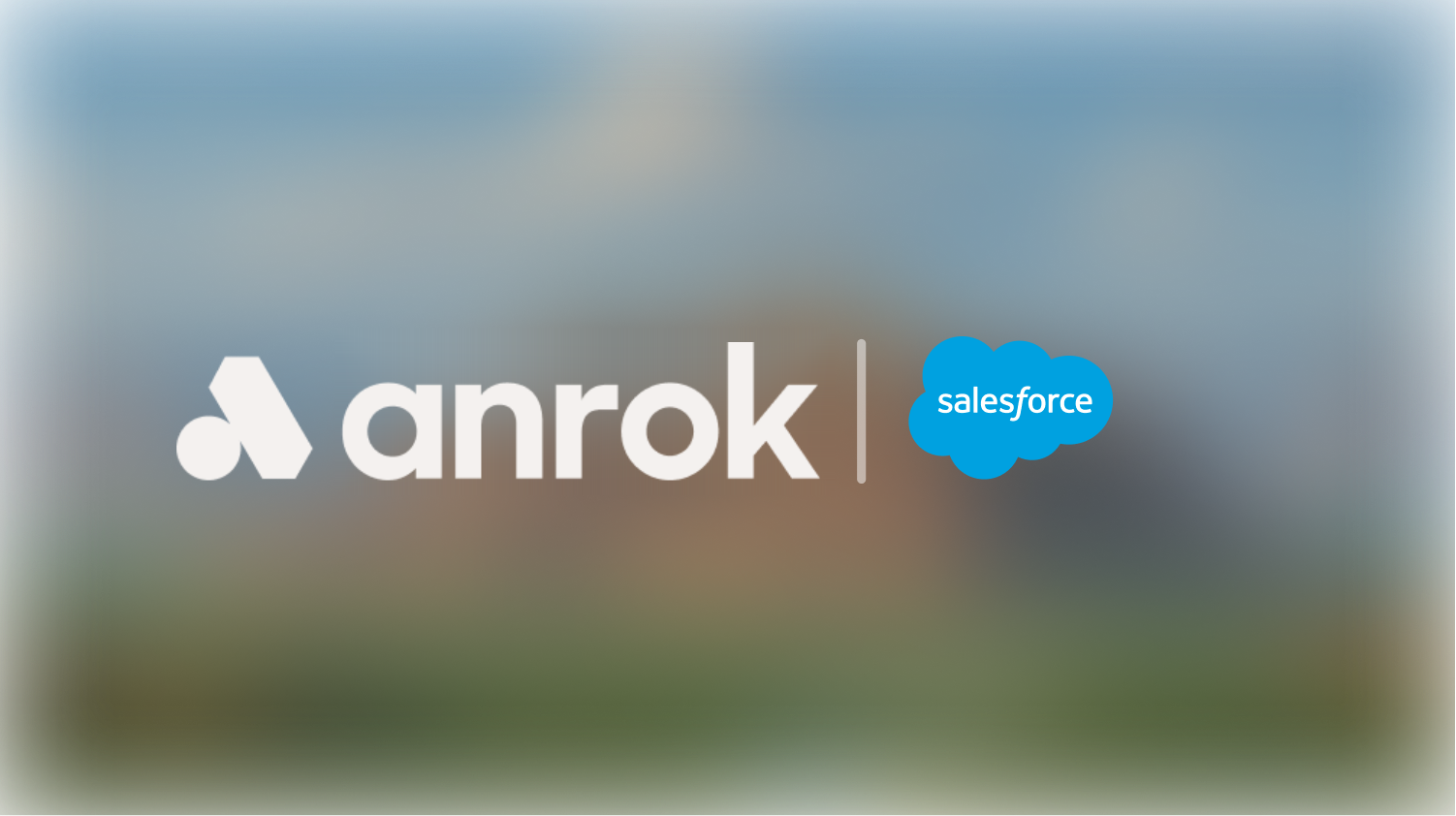 Anrok logo in white next to the Salesforce blue cloud logo on a blurred background.