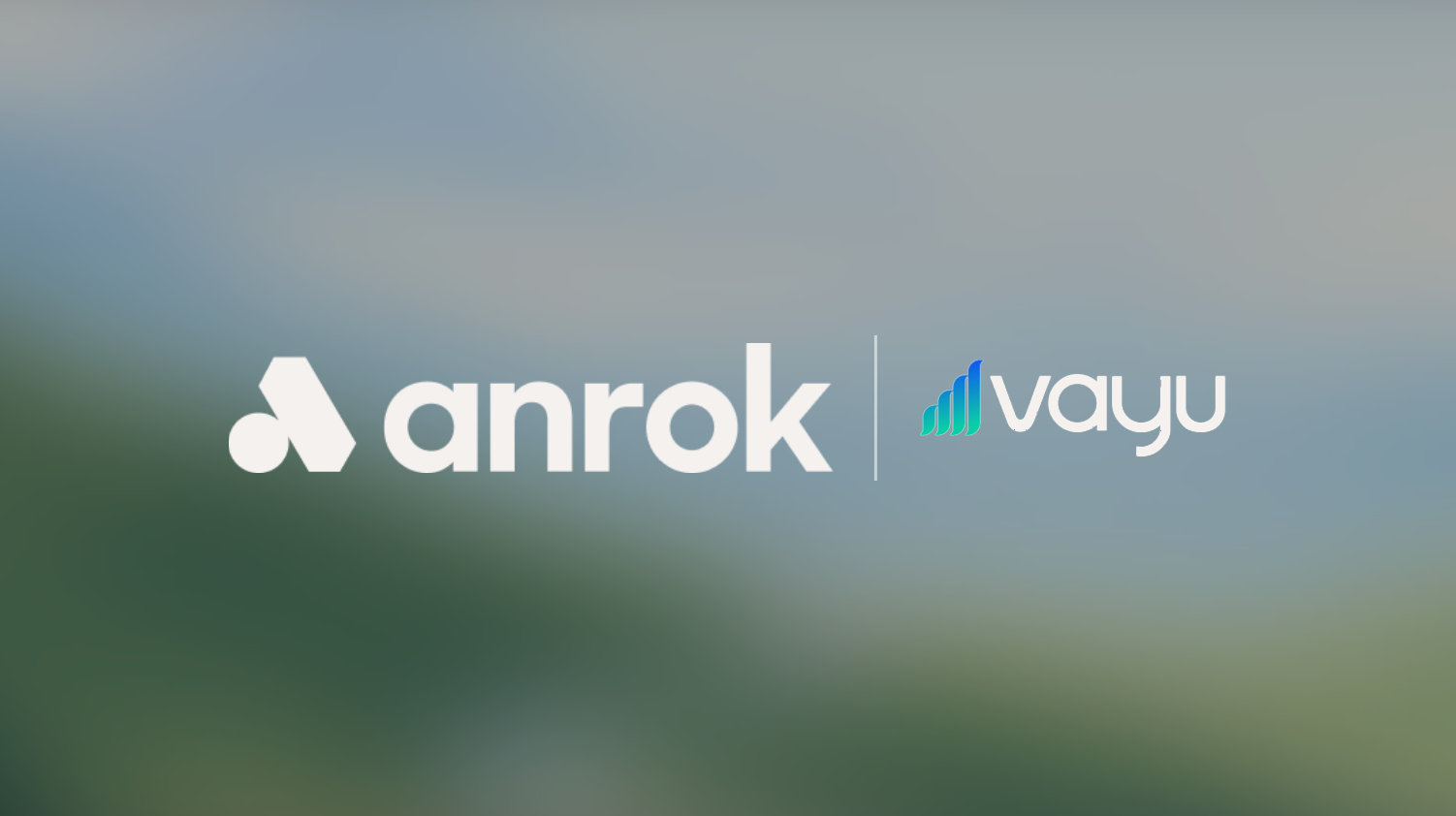Logos of Anrok and Vayu side by side with a vertical divider on a blurred outdoor background.