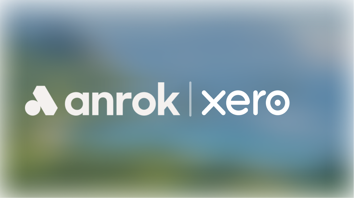 Anrok and Xero logos side by side with a vertical line separating them on a blurred background.