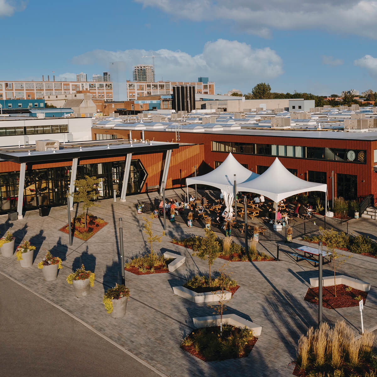 The Catalyst 137 courtyard in use, with tenant frontages along the converted Dominion Tire building