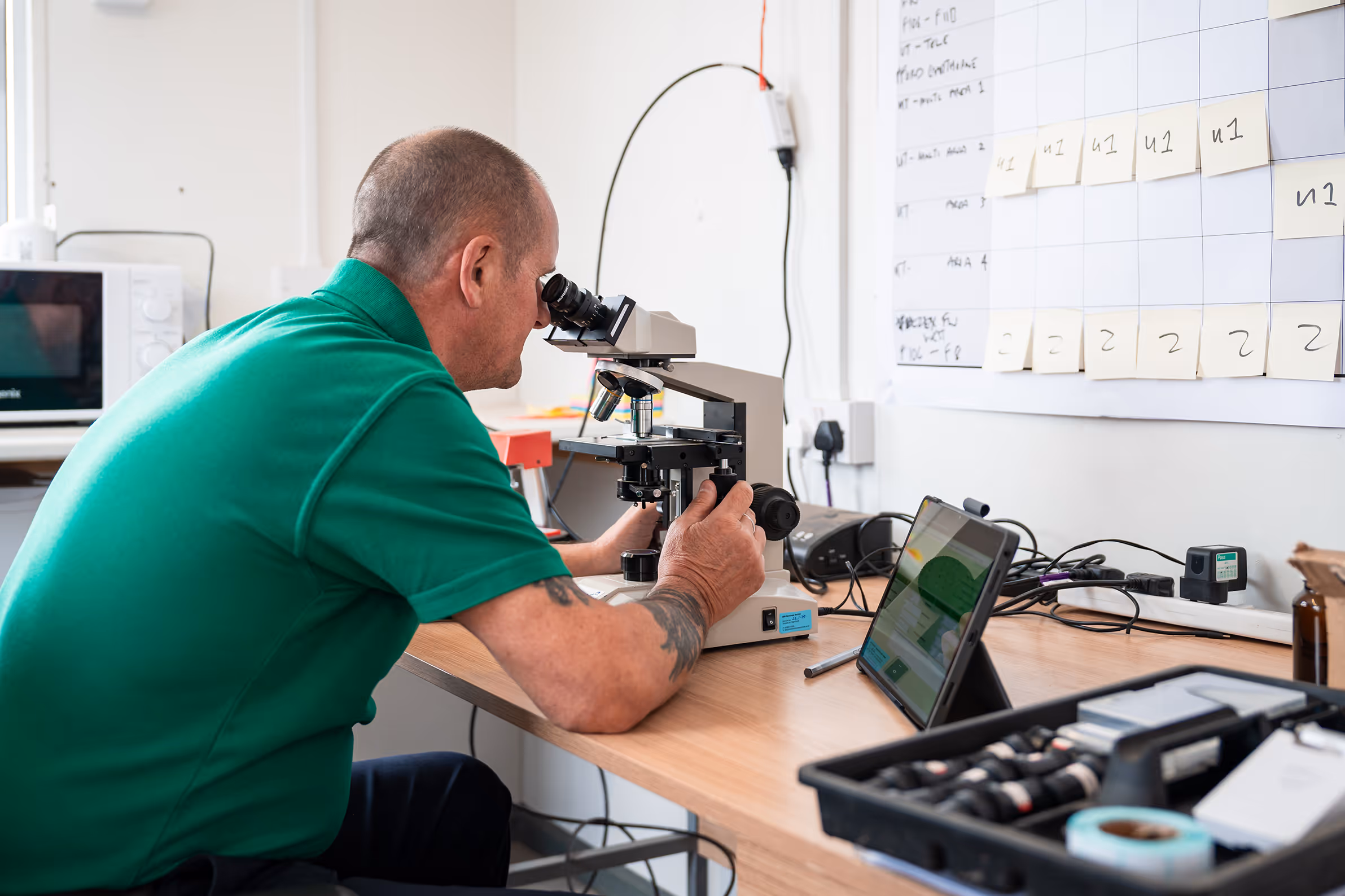 Man working with microscope
