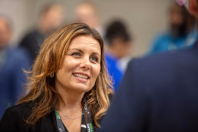 Waste Harmonics Keter employee smiling during a conversation at an industry event