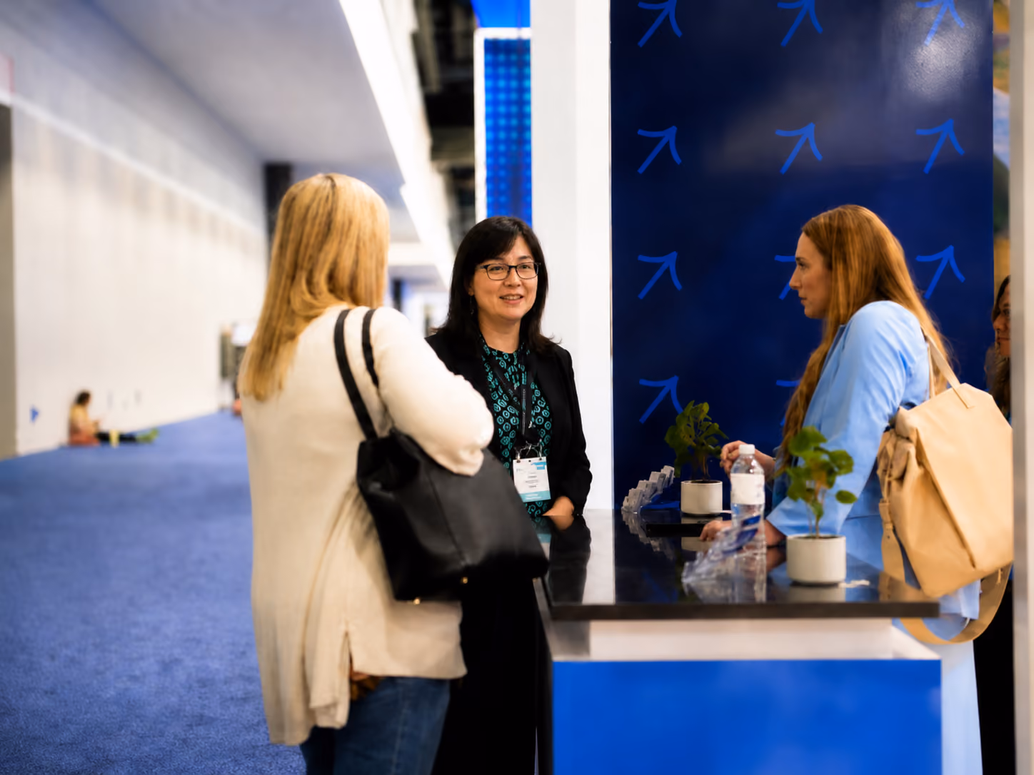 Waste Harmonics Keter team members talking with a visitor at their trade show booth