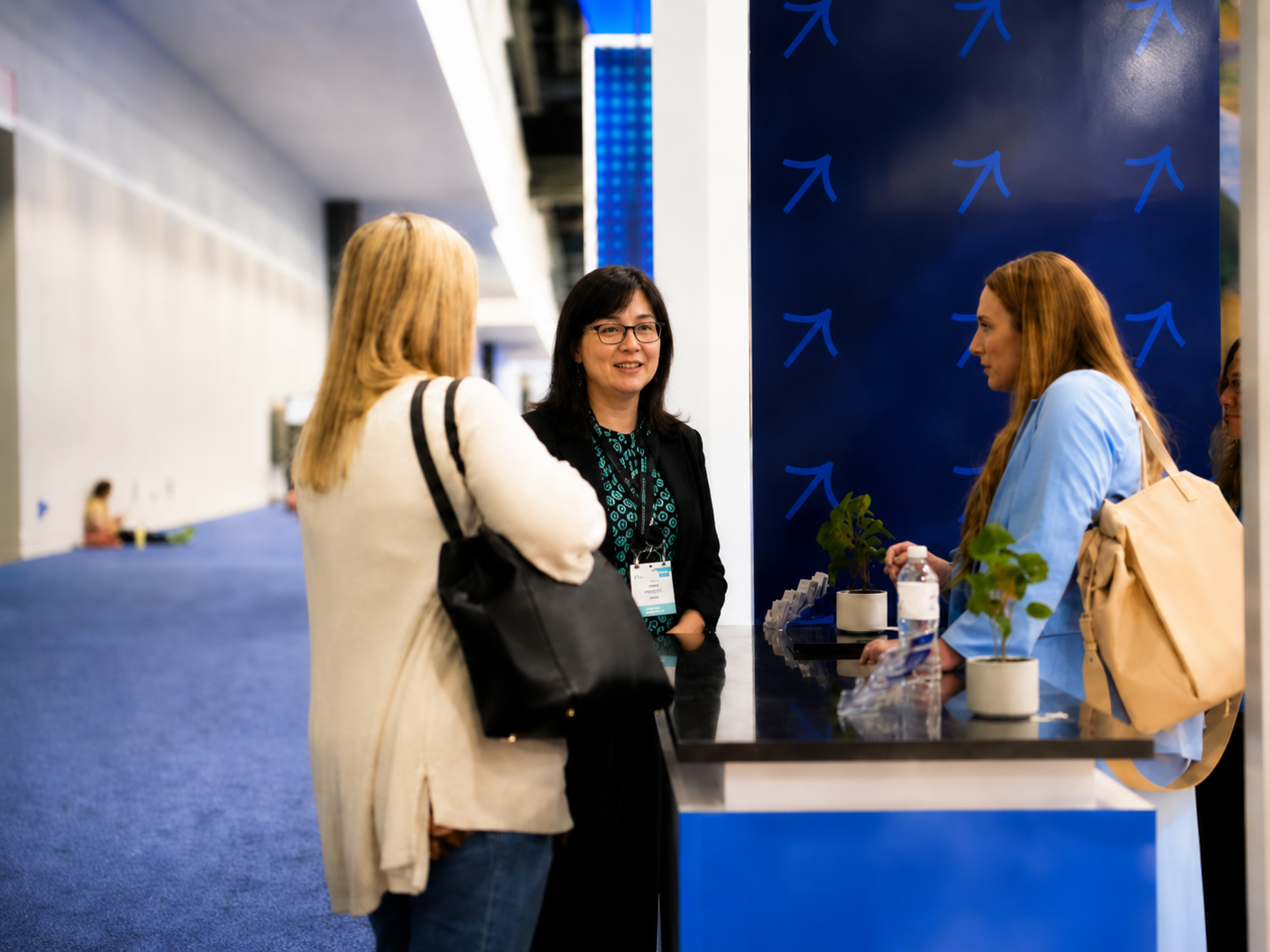 Waste Harmonics Keter team members talking with a visitor at their trade show booth