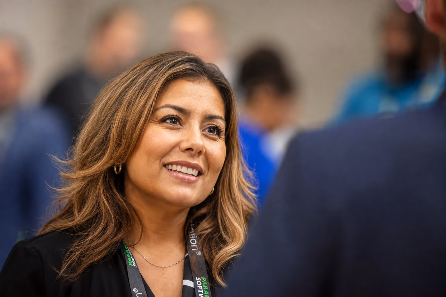 Waste Harmonics Keter employee smiling during a conversation at an industry event