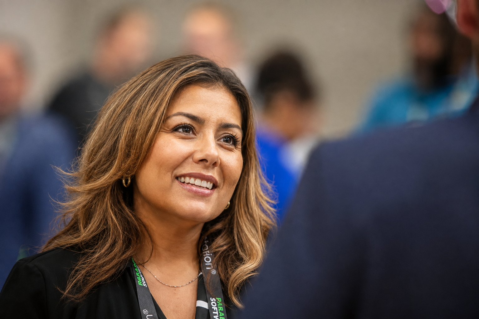 Waste Harmonics Keter employee smiling during a conversation at an industry event