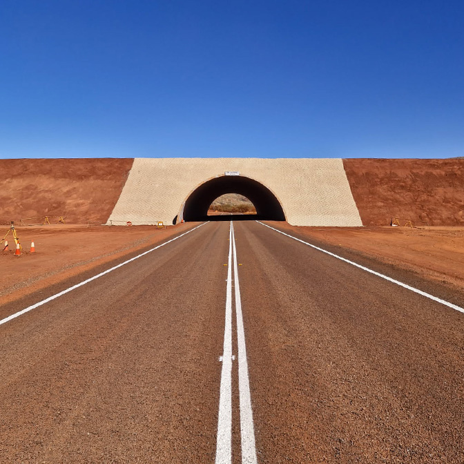 White road line markings leading through an underpass in regional WA