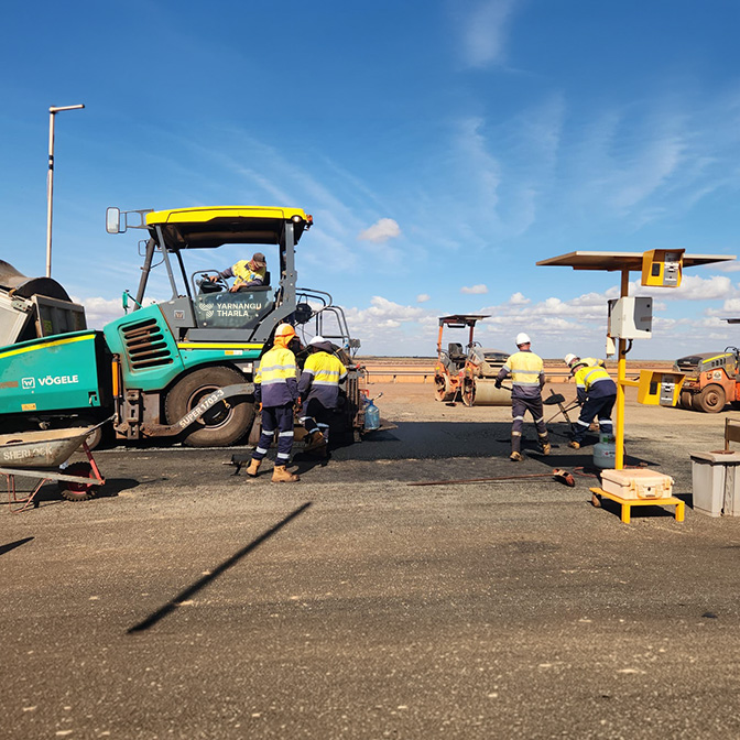 Yarnangu Tharla crew laying asphalt with a road paver in regional WA
