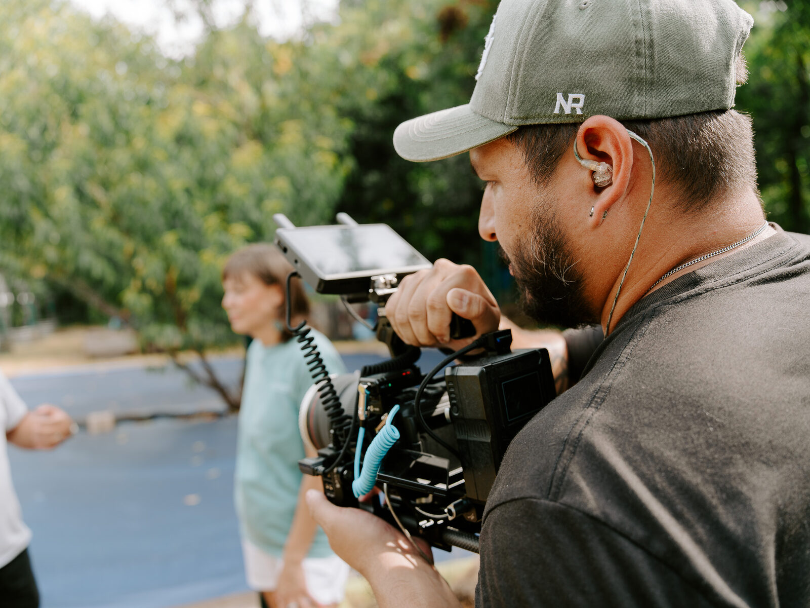 A camera operator films an Oak Cliff Veggie Project volunteer at the community garden