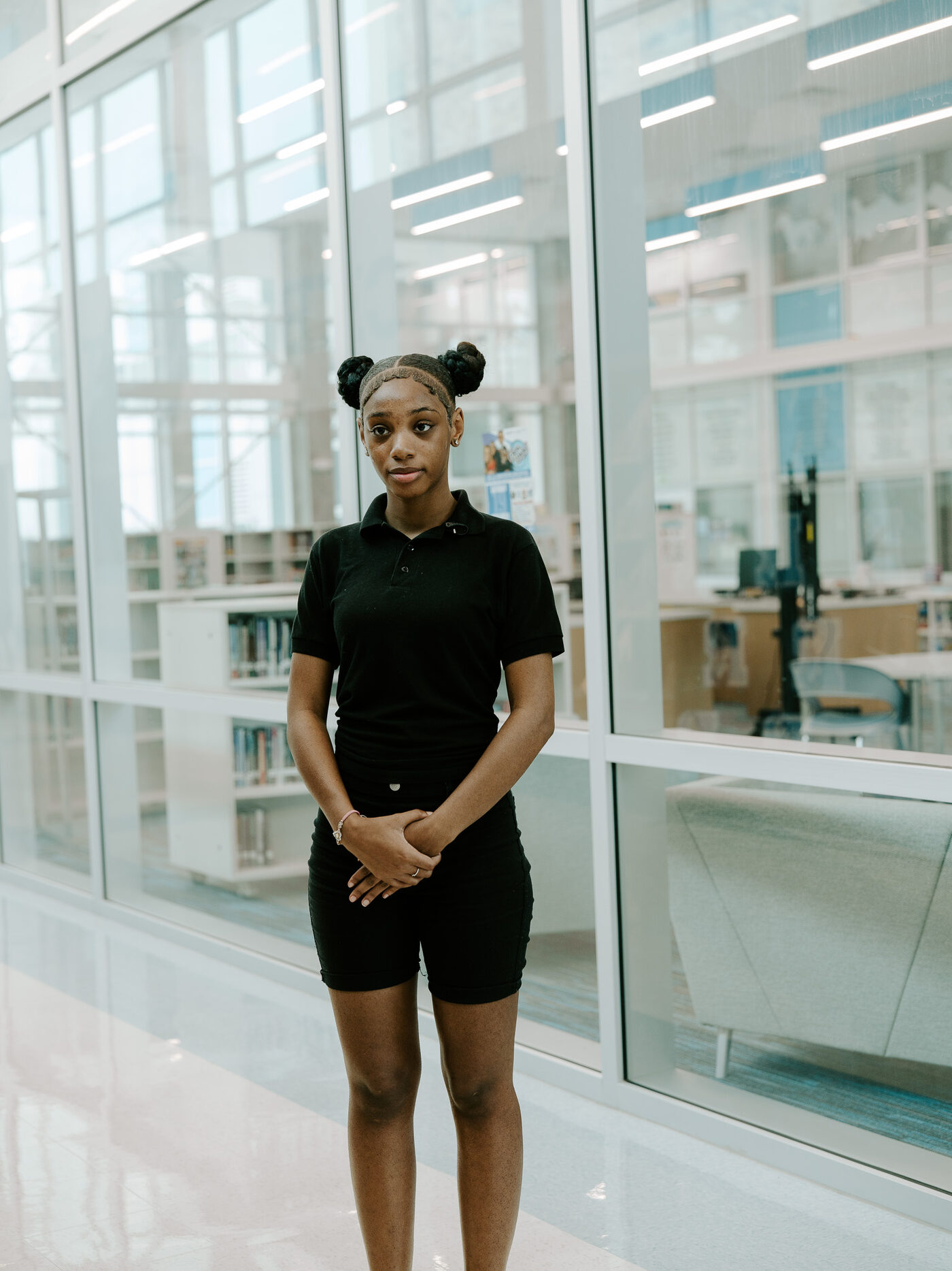 A Roosevelt High School student stands in the school hallway during filming for the campaign
