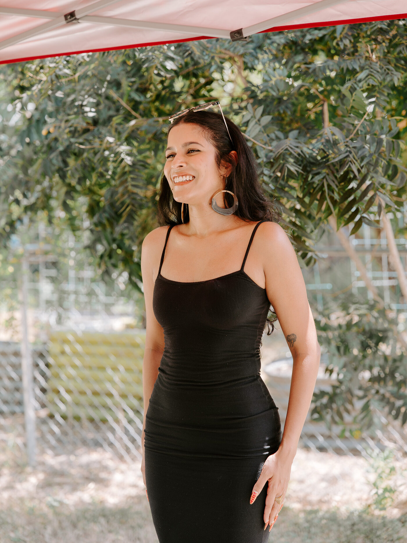 An on-camera host stands in the 10th Street Community Garden during filming