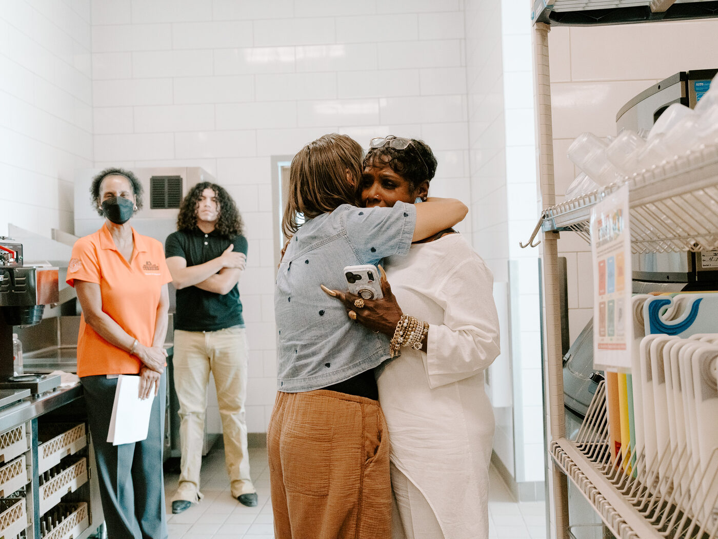 Two people embrace in the Roosevelt High School culinary lab during the shoot
