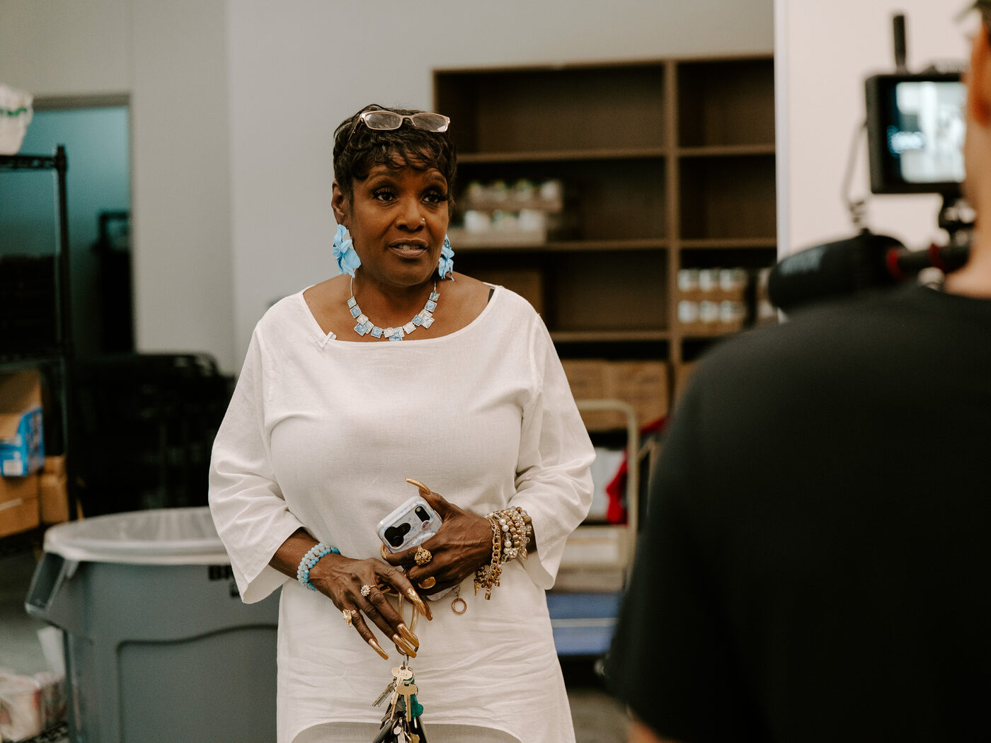 An Oak Cliff Veggie Project team member stands in the organization's food storage room during filming