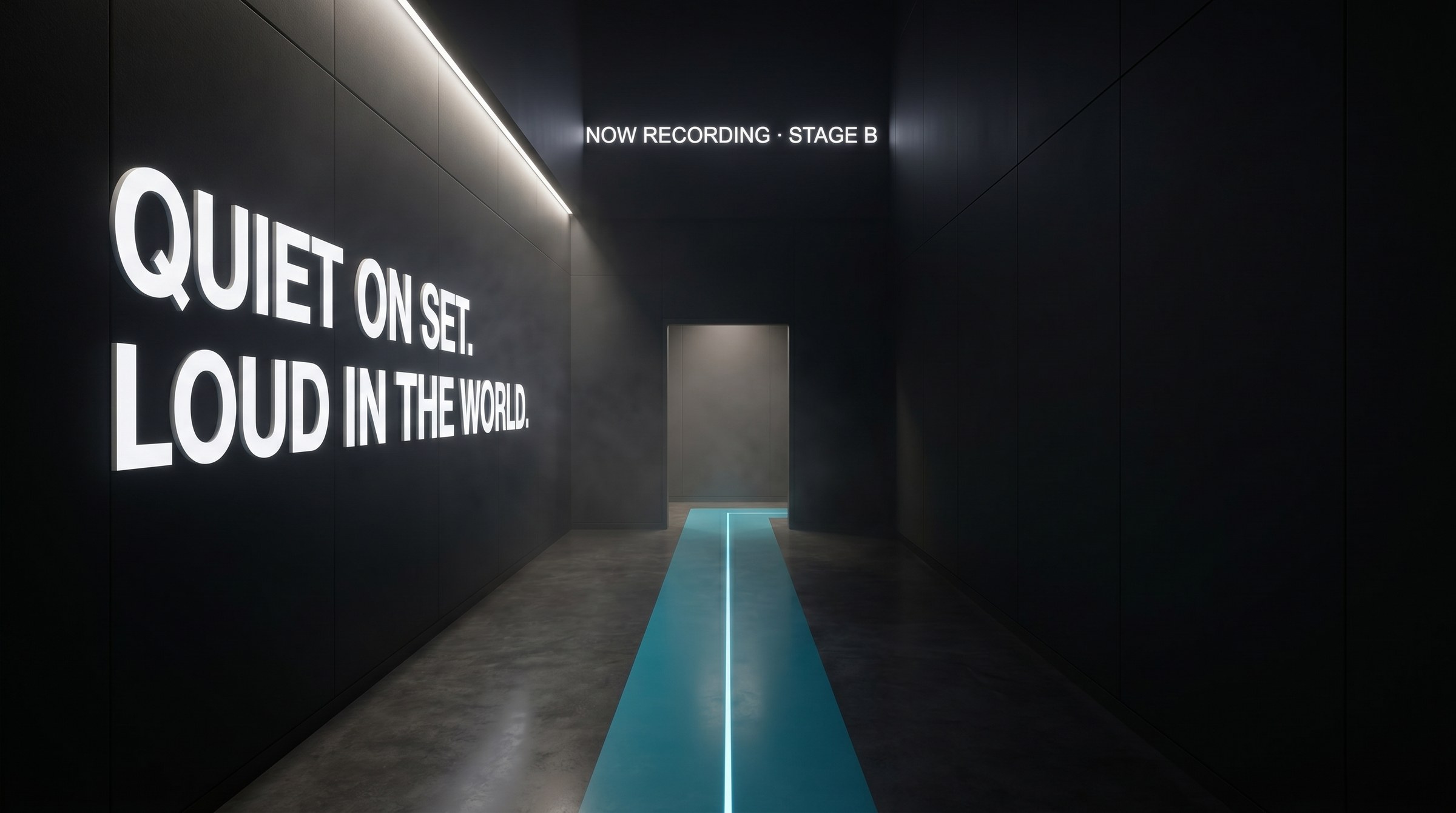 Stage B corridor at The Plex, Fort Worth, with a cyan signal line inlaid in the floor and the wall reading Quiet on set. Loud in the world. Environmental design by Good Word Agency