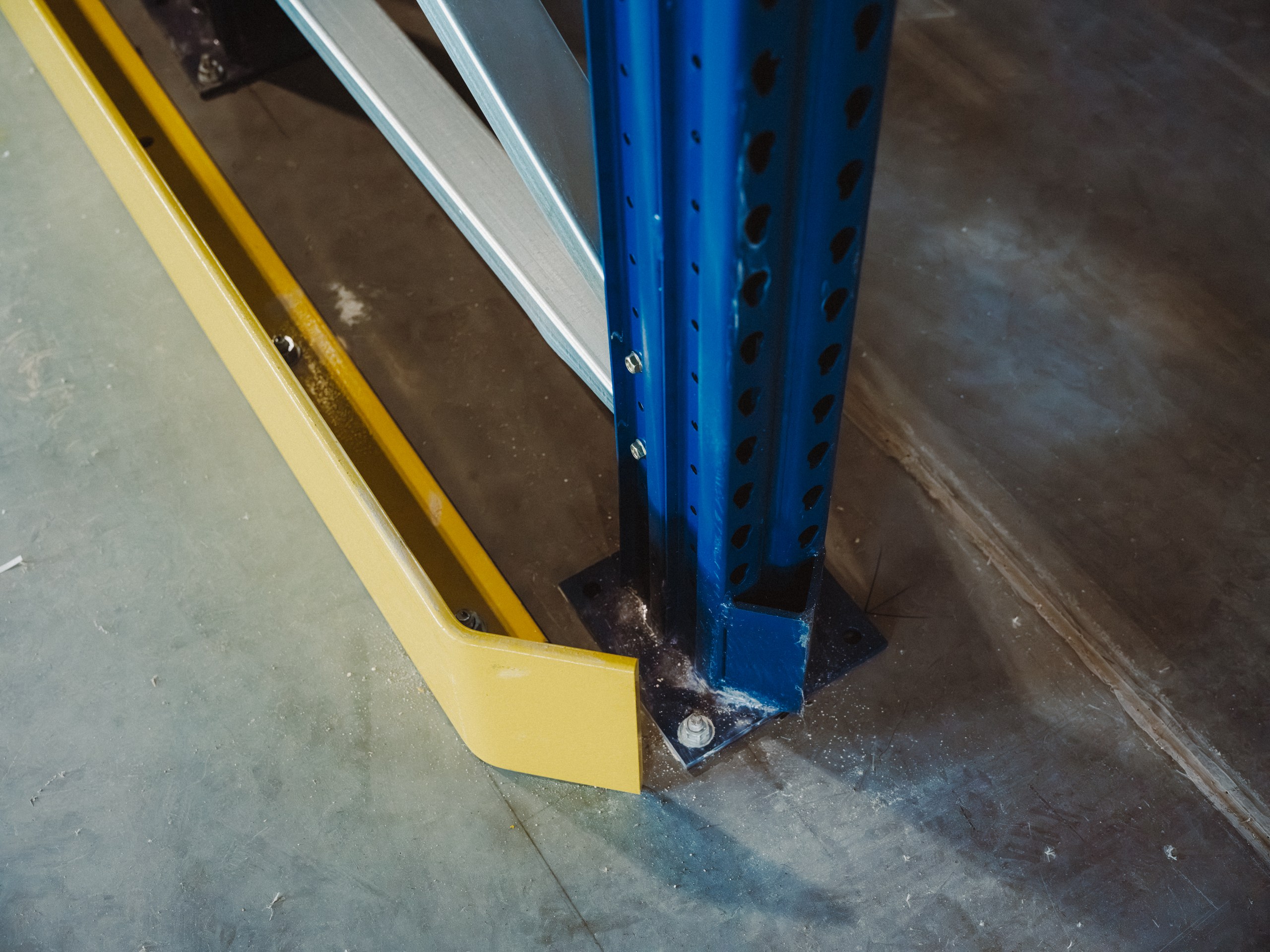 Close detail of a racking upright, floor fixing and column guard