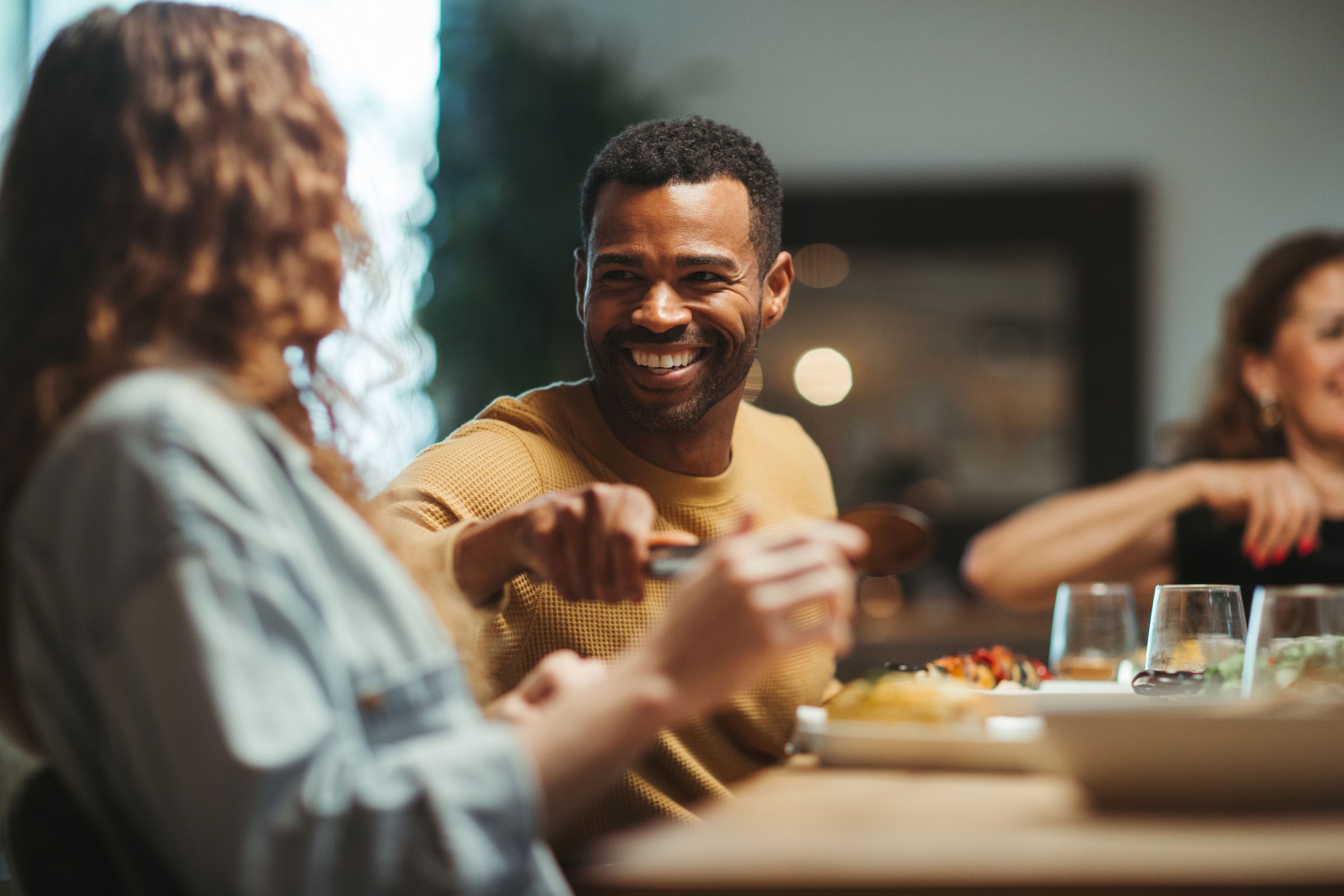 Friends eating together at a table, sharing 27 Peaks baked snacks