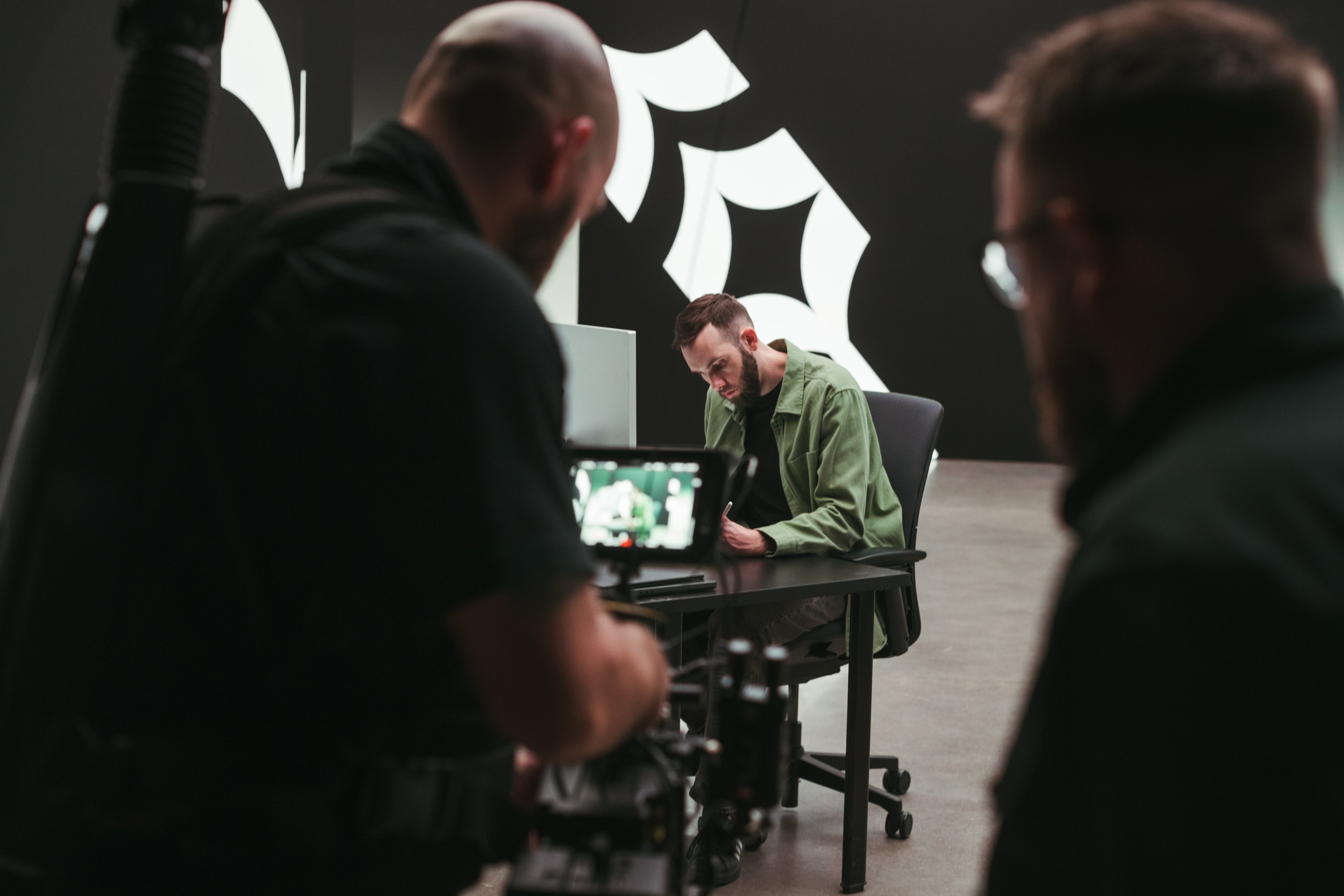 Operator filming over the shoulder of the director