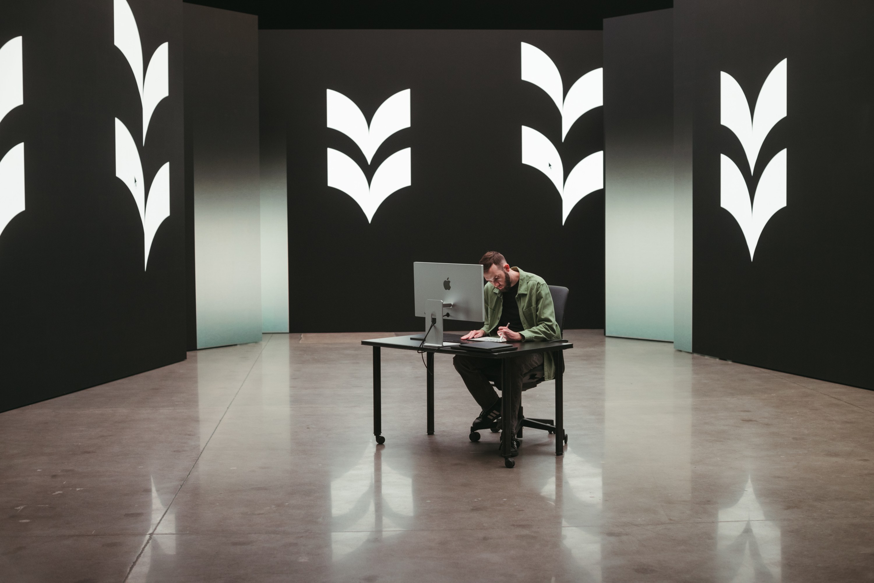 Subject at a desk framed by Good Word shape elements
