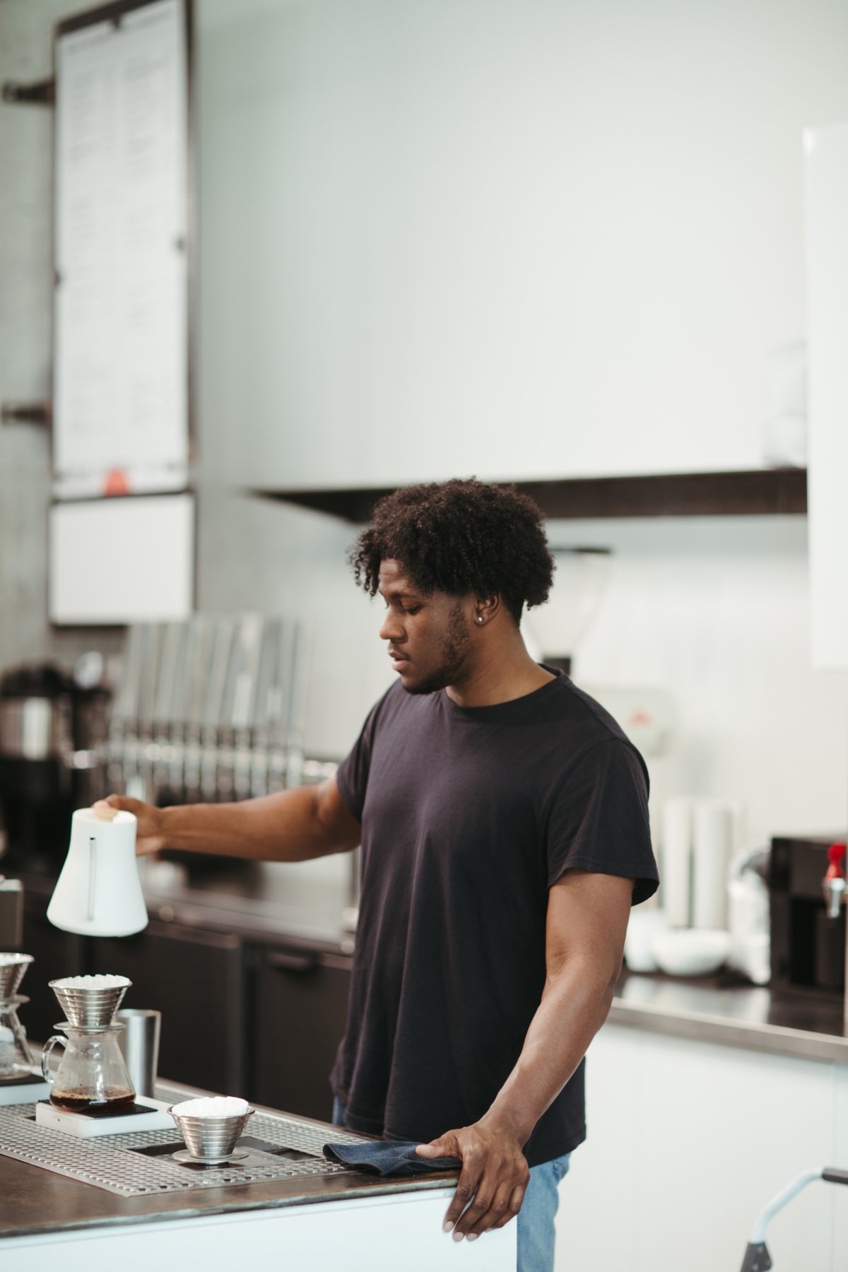 Man making pour-over coffee in a kitchen