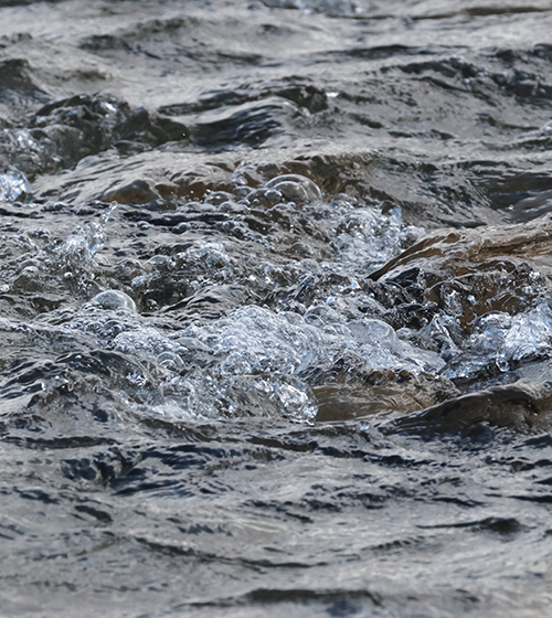 Fast-flowing river water showcasing sustainable freshwater management and catchment hydrology solutions