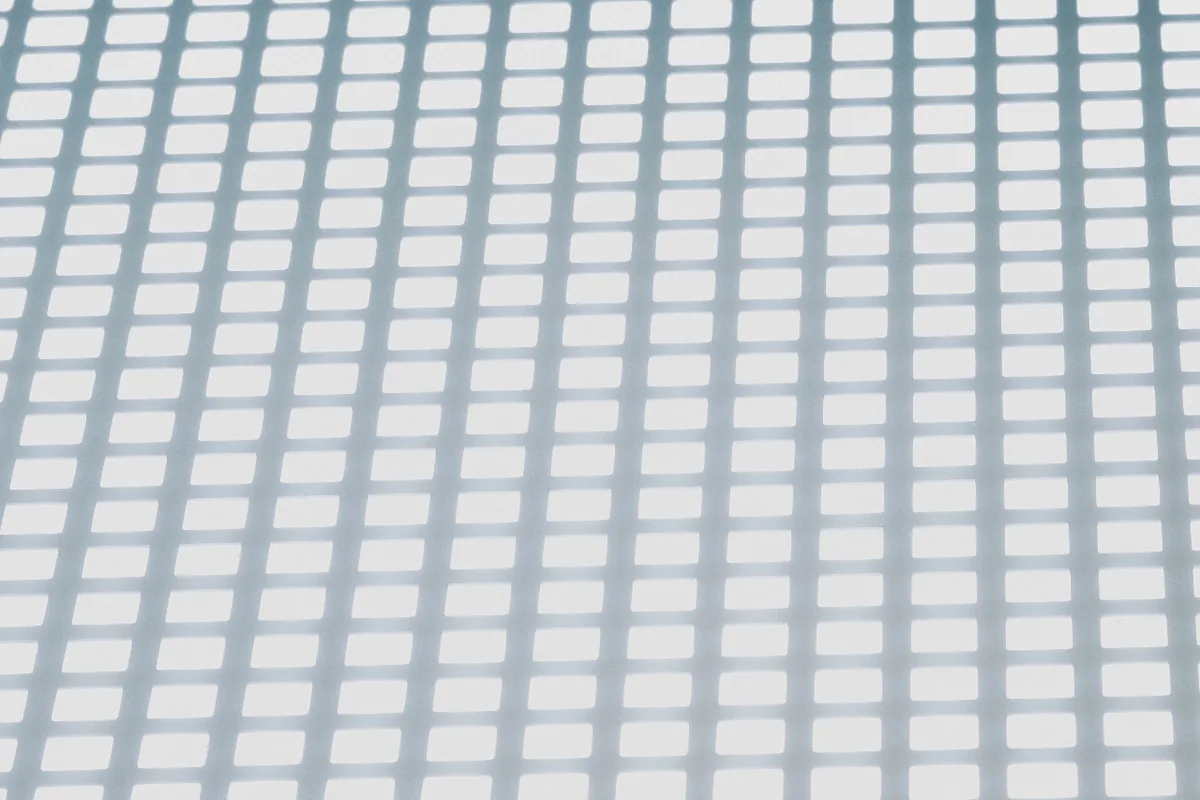 Fine architectural grid in daylight, representing the clean data signals automated bidding depends on