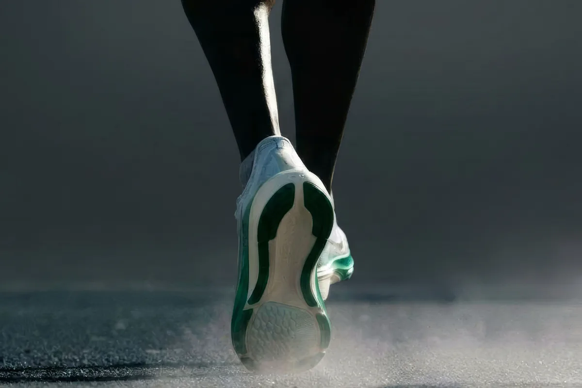 A runner's foot striking dusty ground, representing sustained effort in a campaign