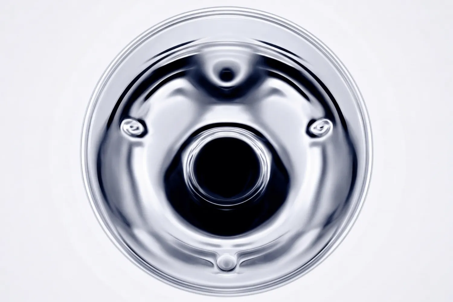 Polished chrome disc on a white background