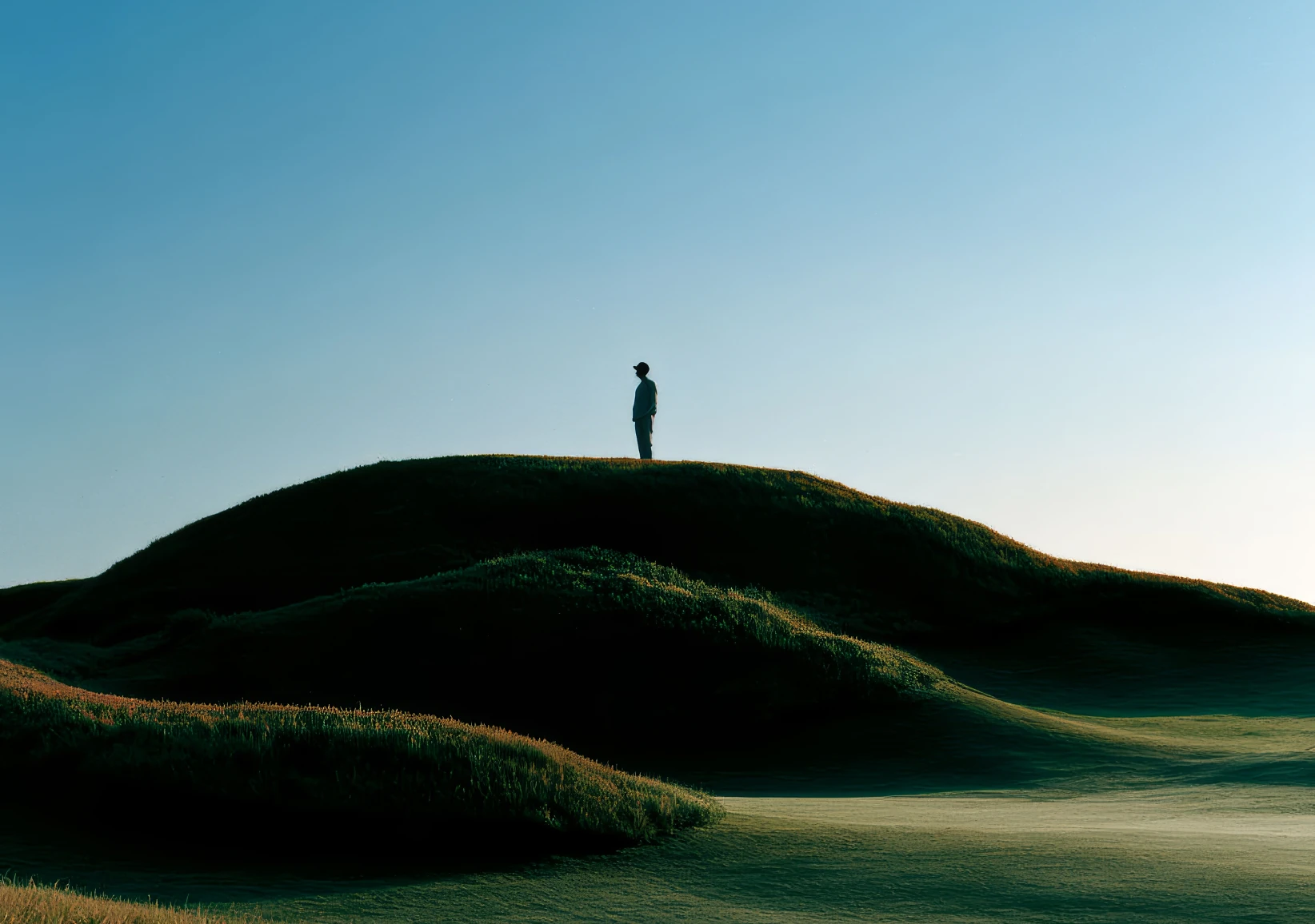 Lone figure standing on a green hill, Millard Financial case study