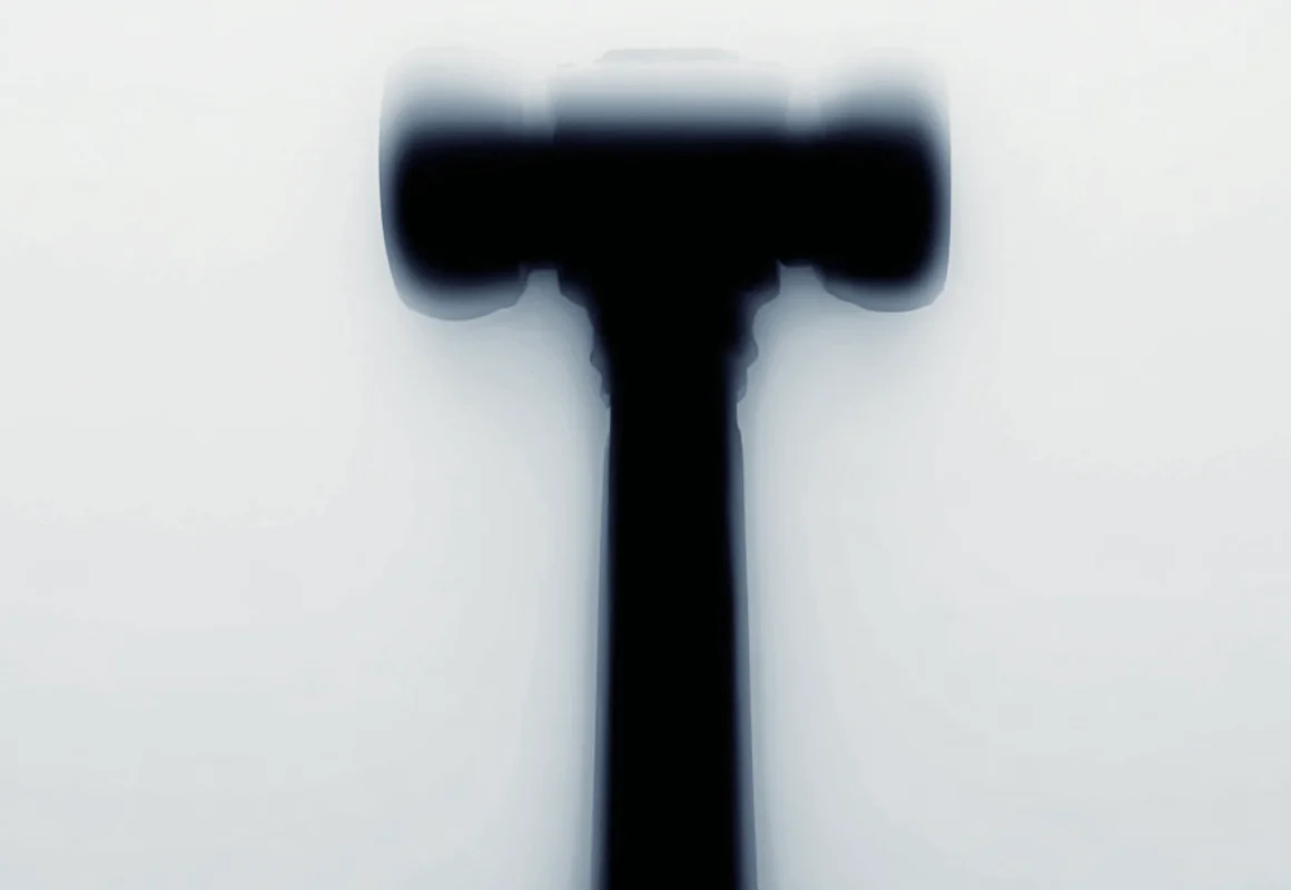 A hammer blurred against a pale background