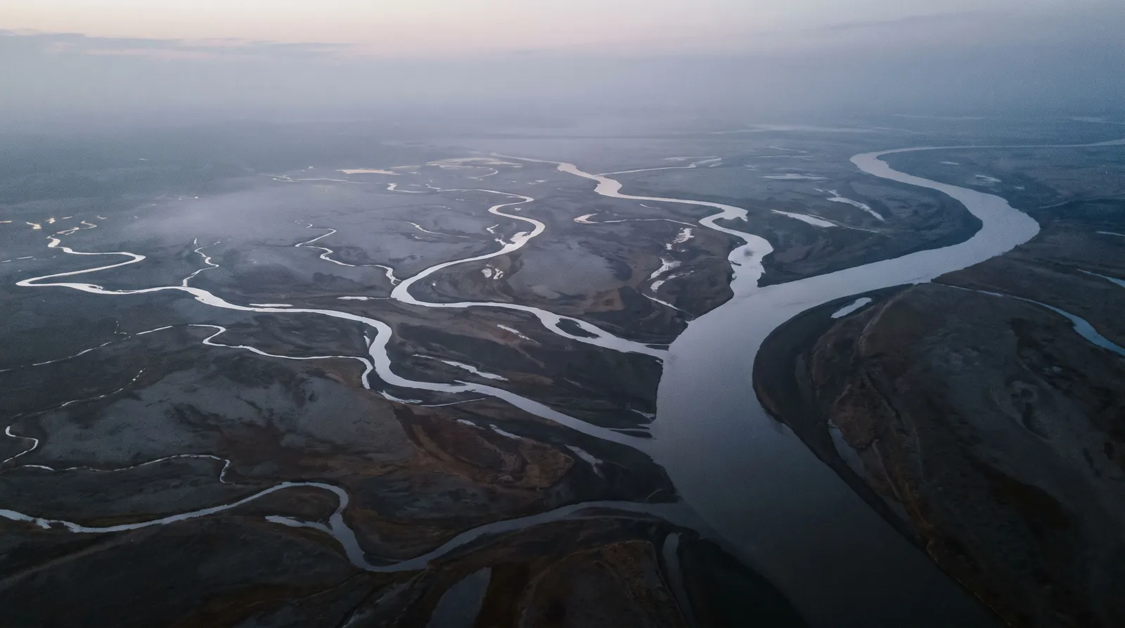 River channels converging into one main channel, seen from above at dusk
