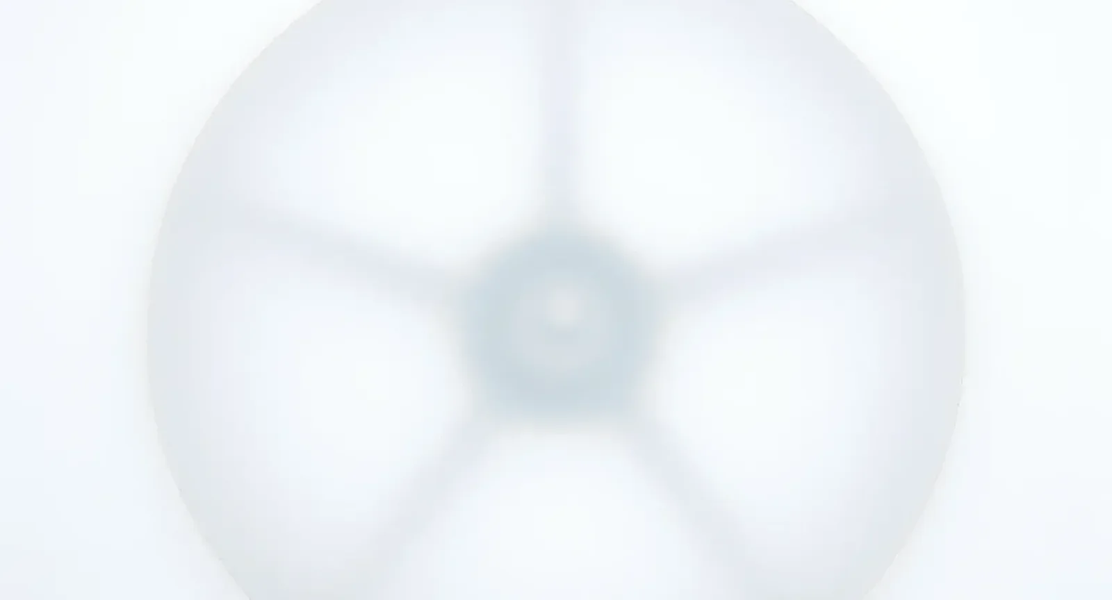 A translucent wheel softly blurred on a white background