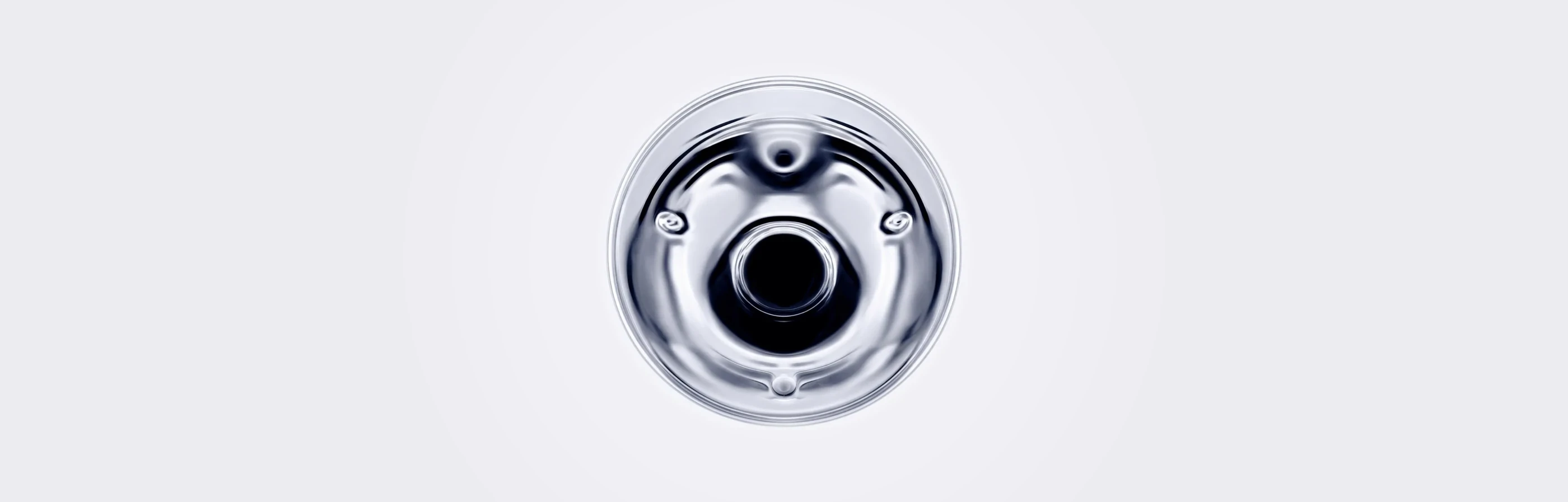 A polished glass disc seen from above on a pale background